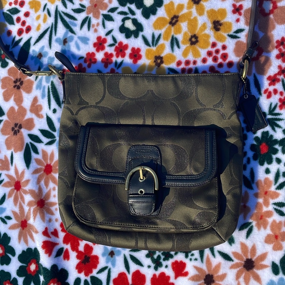 Coach medium sized cross body bag army green exterior with golden buckles.